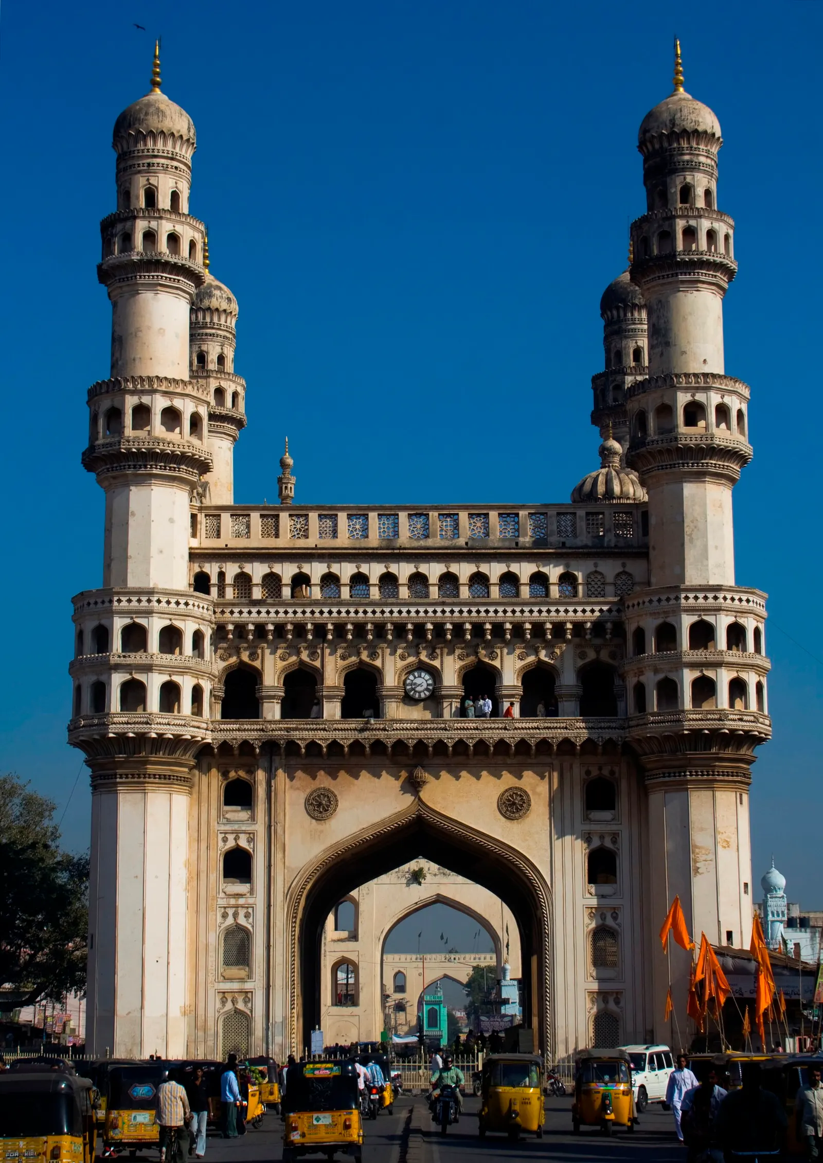 The four minarets of the Charminar lit at dusk above the old city bazaars of Hyderabad